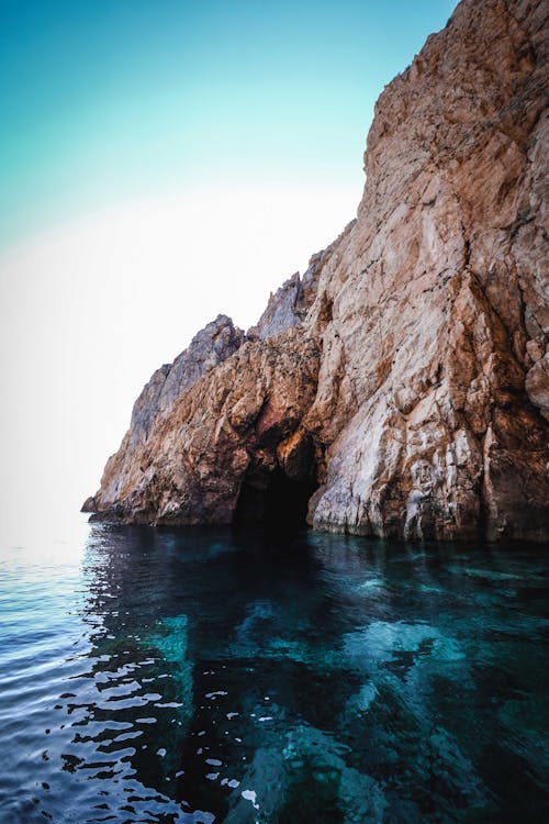 Rocky cliff in turquoise sea water