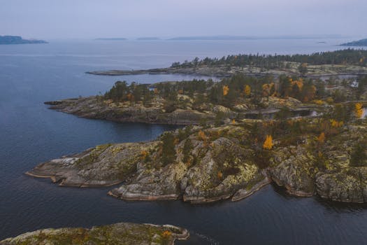 Stunning aerial shot of Ladoga Skerries National Park in autumn, showcasing vibrant fall colors and rocky formations.