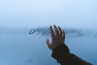 Person in Black Pants With Right Hand on Water