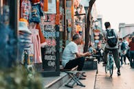 Elderly Man seated on a Storefront