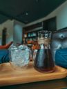 Clear Glass Pitcher on Brown Wooden Table
