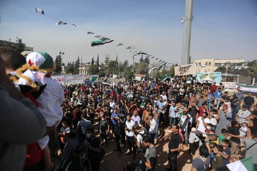 Free Aerial view of a large crowd protesting outdoors in Syria under clear skies. Stock Photo