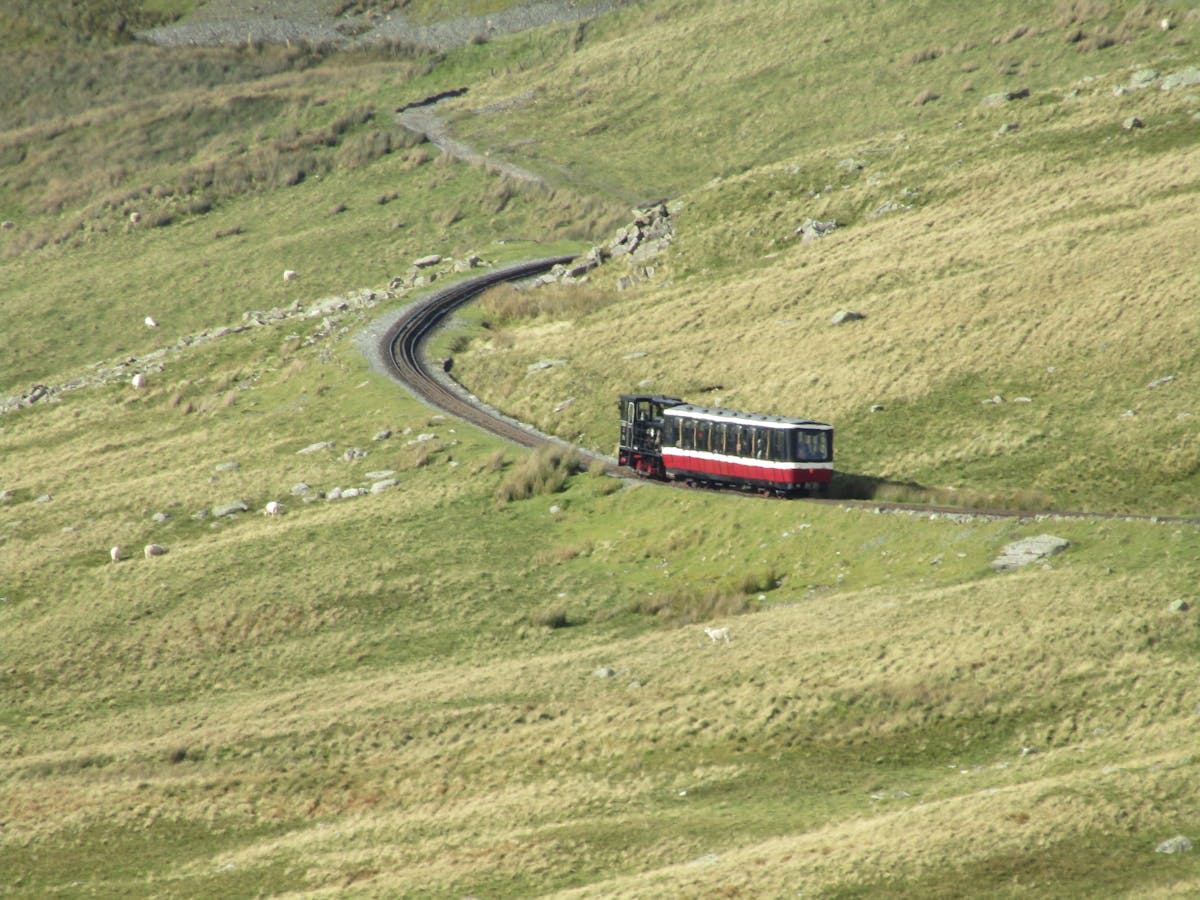 A cozy minimalist bedroom with neutral bedding, simple furniture, and soft lighting