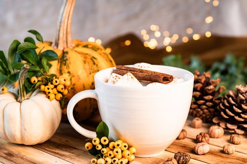 Free Warm autumn setup with coffee, pumpkins, cinnamon, and rustic decor on a wooden table. Stock Photo