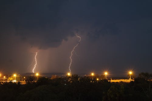 Lightning over dark city with buildings