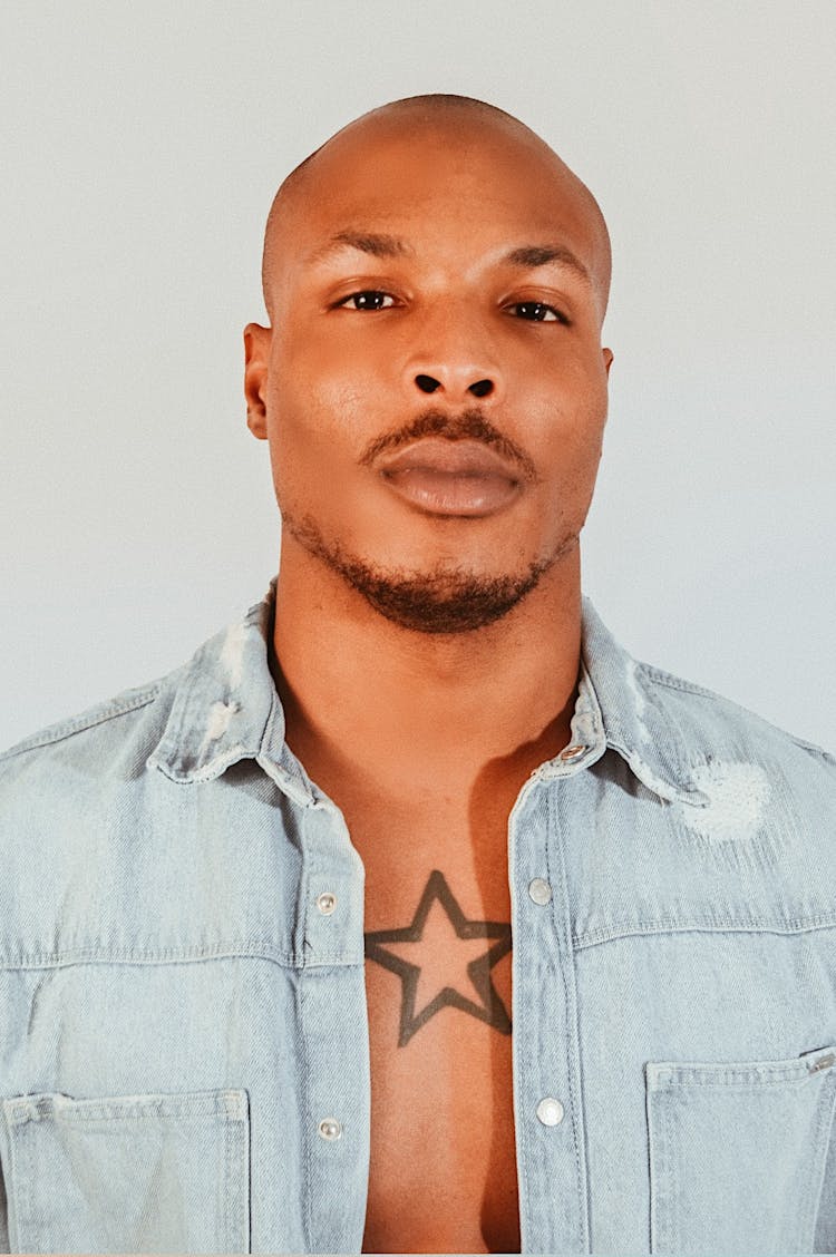 Portrait Of A Man With Star Tattoo On A Chest