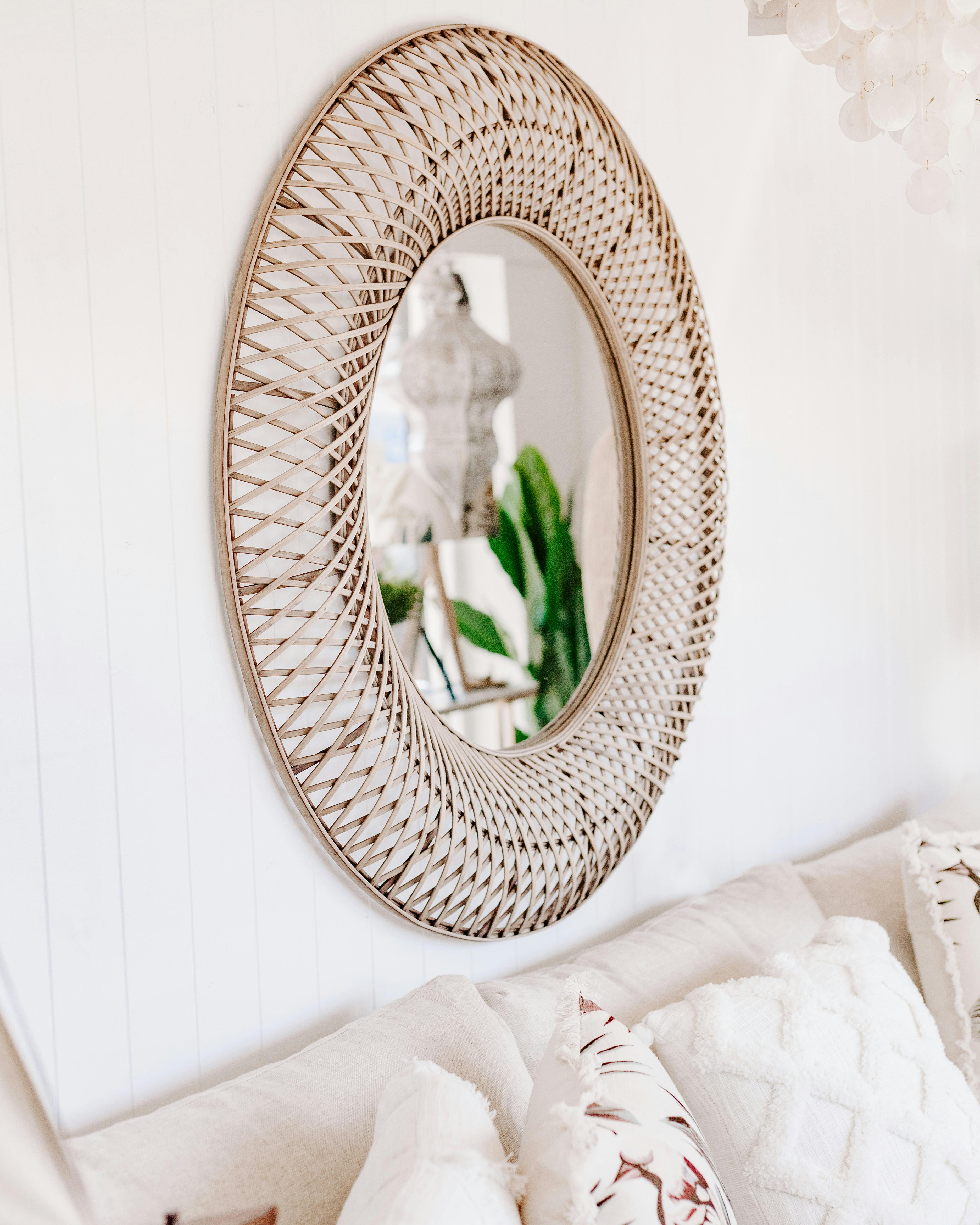 Creative oval shaped mirror on wall in living room · Free Stock Photo
