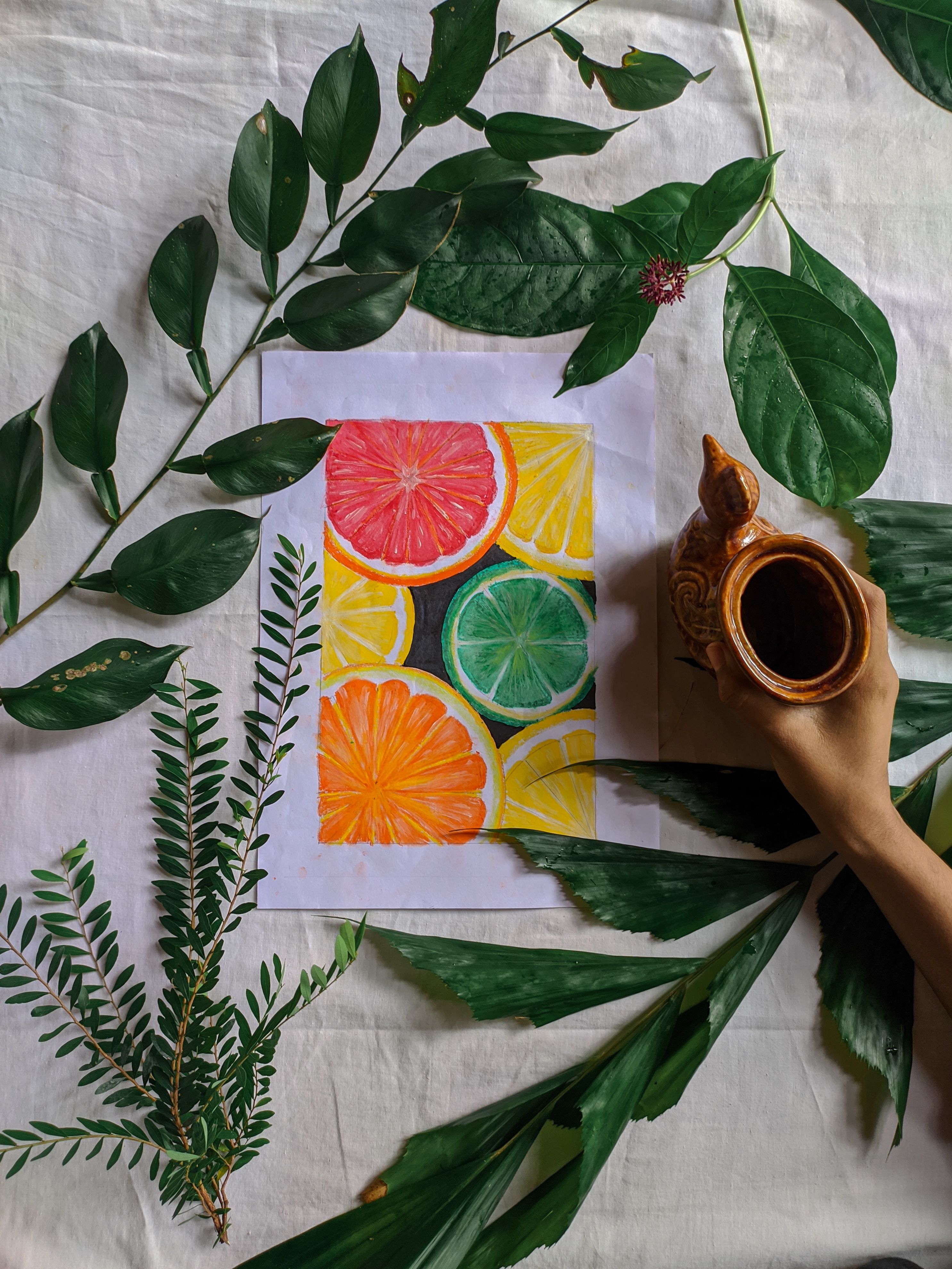 Vibrant citrus fruit drawing surrounded by green leaves, capturing a natural and artistic look.