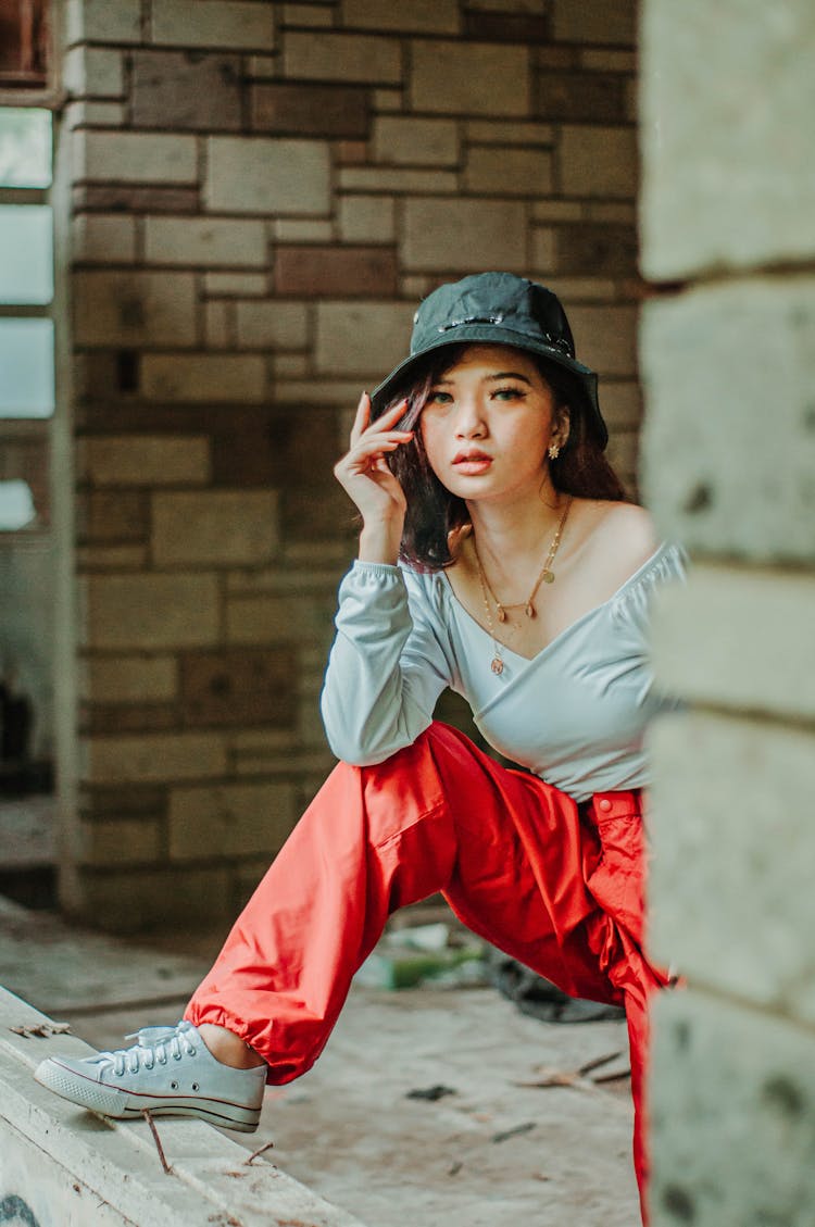 Asian Woman In Old Building Putting Foot On Window Opening