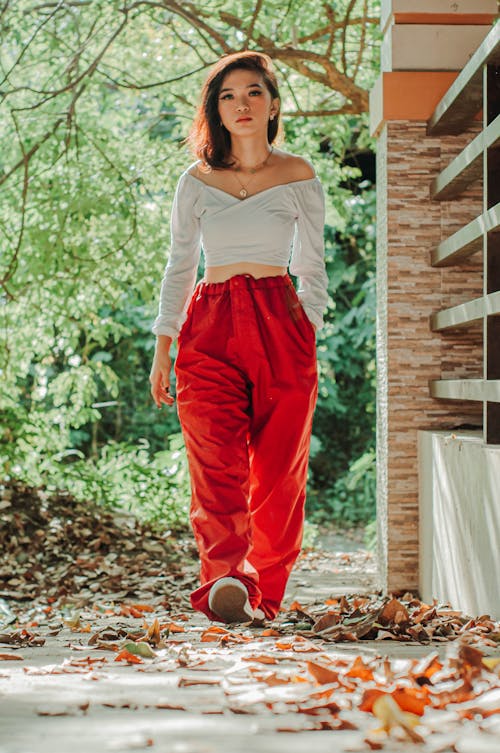 Asian female walking on withered leaves