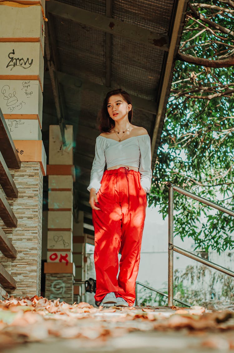 Stylish Asian Teen Under House Canopy And Tree