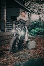 Cool woman on motorcycle near building