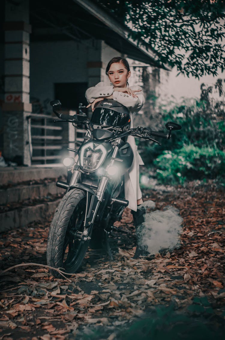 Cool Woman On Motorcycle Near Building