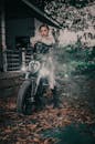 Trendy woman on motorbike in dark autumn