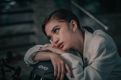 Charming woman with makeup on motorcycle