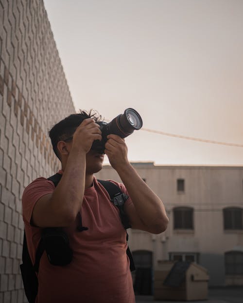 Man taking Photograph with Long Telephoto Lens Camera
