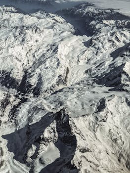 Stunning aerial view of snow-capped mountains in the Swiss Alps during winter.