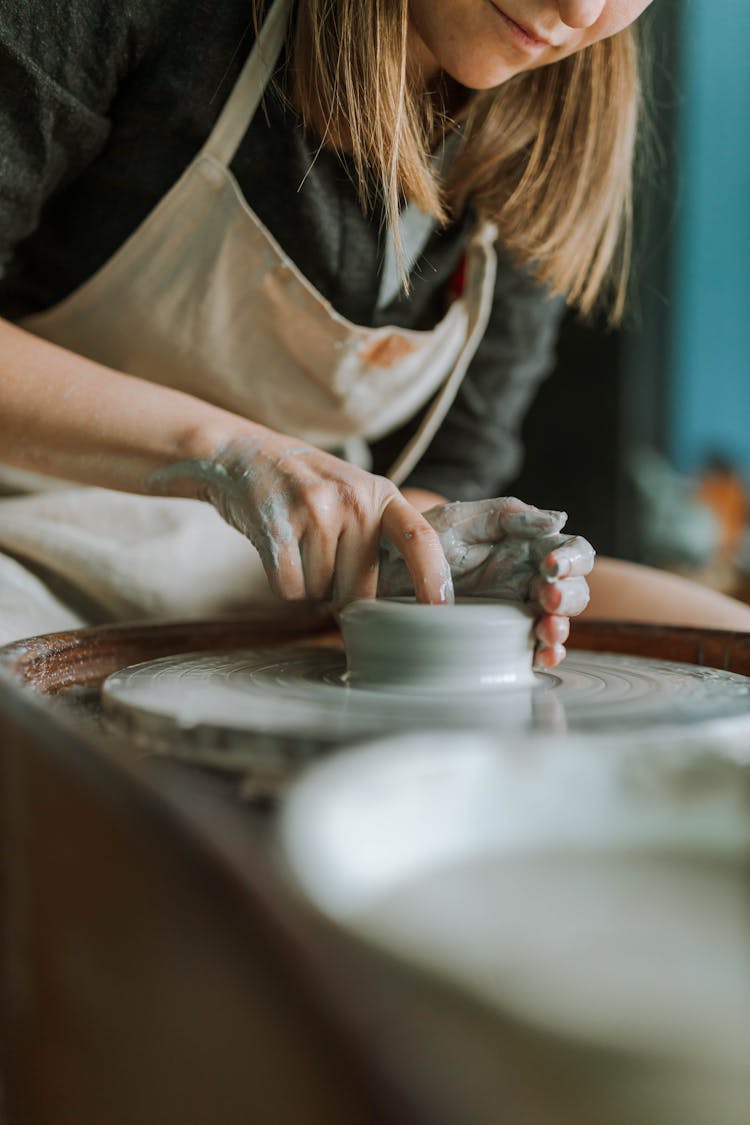 Woman Shaping A Soft Clay