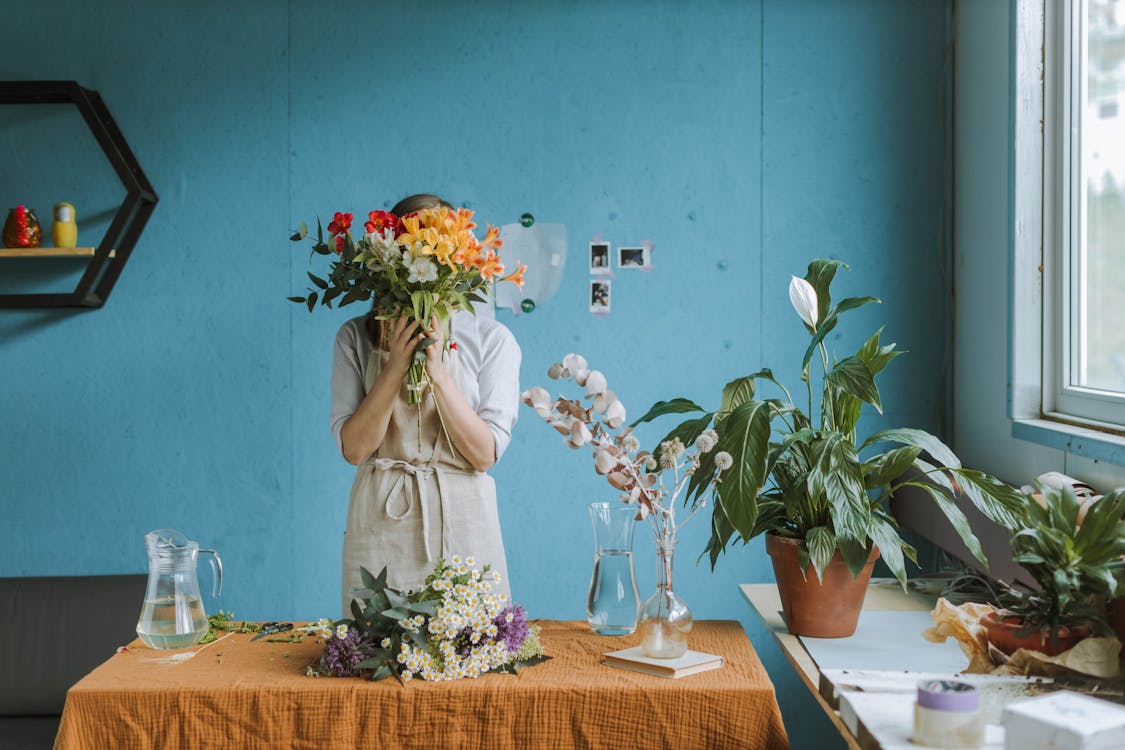 Free Woman in White Dress Holding Bouquet of Flowers Stock Photo