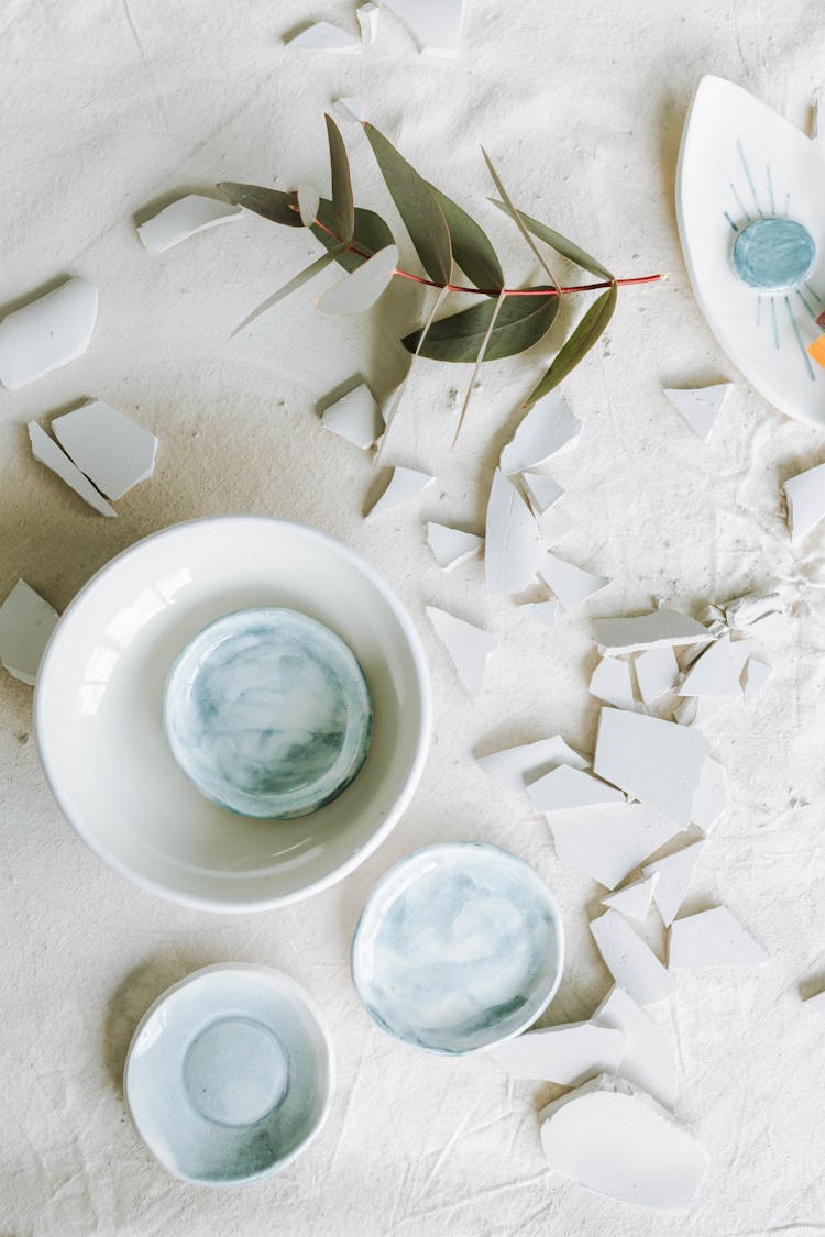 Ceramic Bowl Near Shattered Ceramic Pieces 