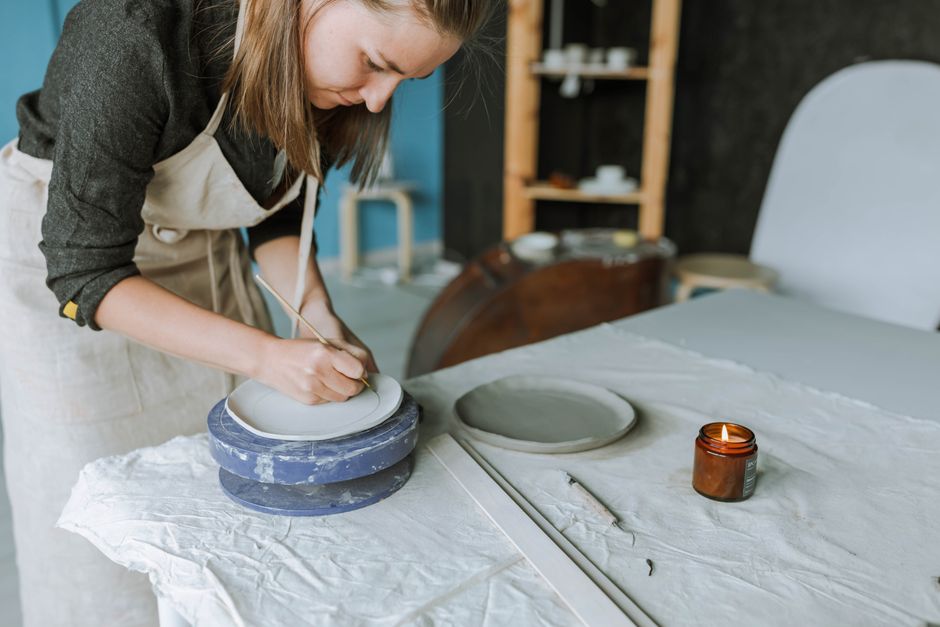 How Ceramic Nonstick Cookware Solves Safety Concerns Compared to Teflon A craftswoman intricately sculpts pottery in a serene studio setting, showcasing hands-on craftsmanship.
