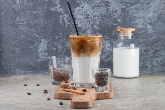 Delicious iced coffee with milk on a wooden tray, perfect for a caffeine boost.