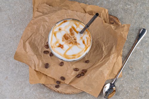 A Glass of Cold Coffee Drizzled with Caramel Syrup