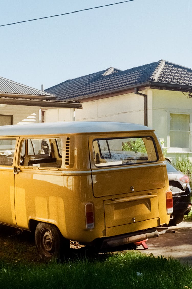 Yellow Van Parked In Front Of A House