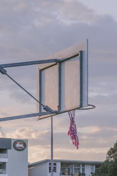 A basketball hoop with netting against a morning sky in Zetland, Australia.