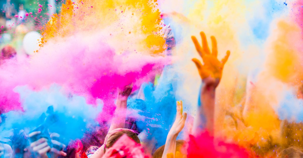 Vibrant festival crowd enjoying outdoor celebration with colorful decorations