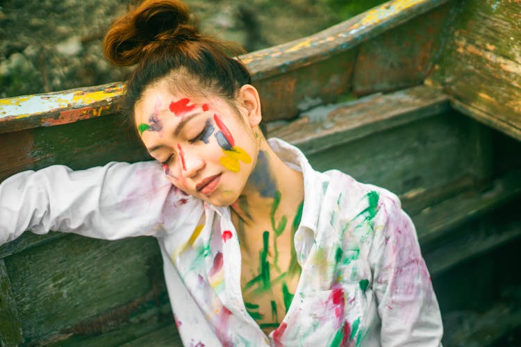 Sensual Woman In Paint Spots Sitting In Old Boat