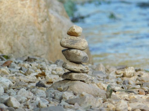 Pila Di Pietra Grigia Accanto Al Corpo D'acqua