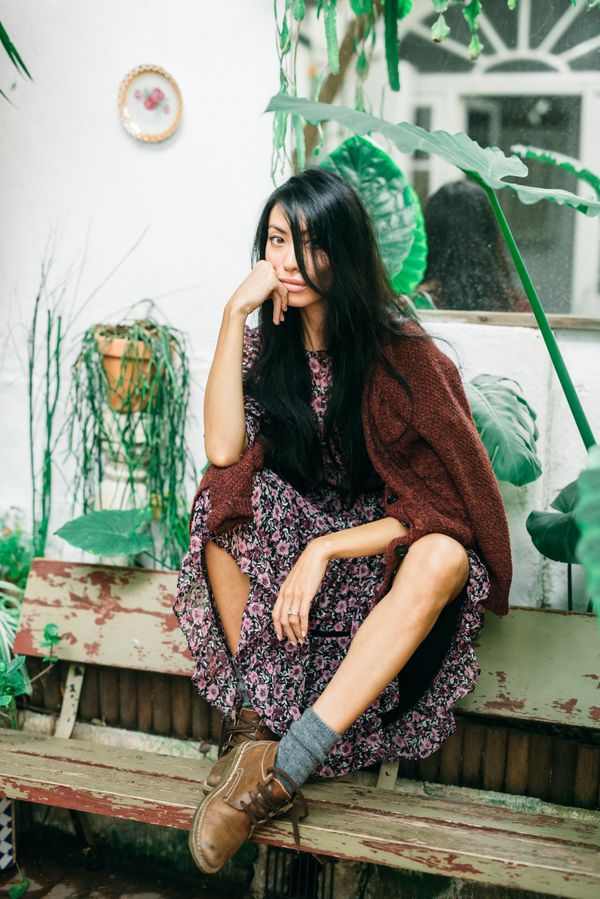 Brown cardigan layered over a floral midi dress