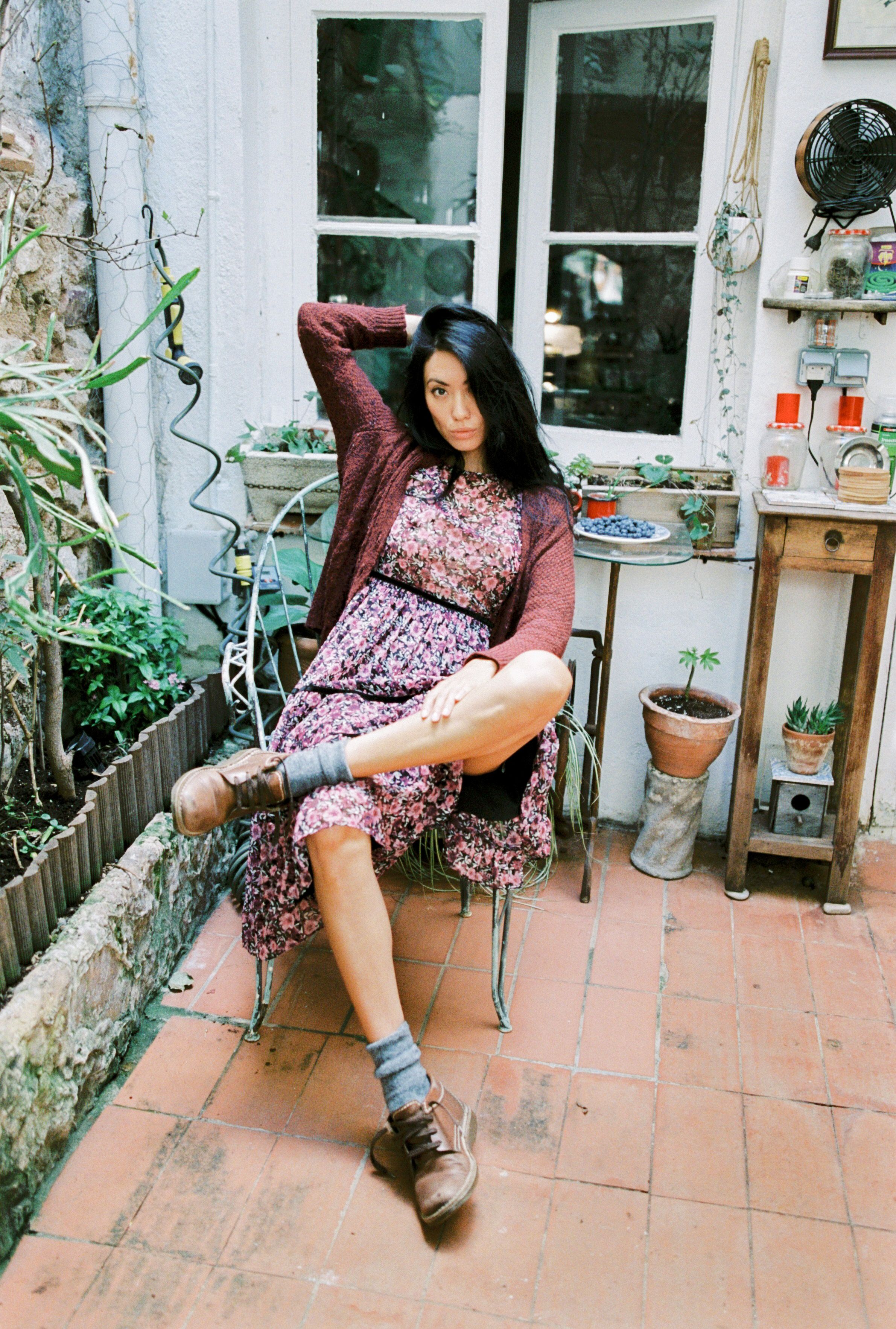Woman Wearing Knitted Sweater Posing While Sitting · Free Stock Photo