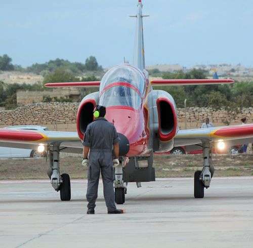Free Ground crew member marshaling a jet at Malta's Luqa Airport. Stock Photo