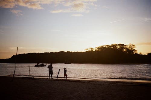 Silhouette of People by the Lake