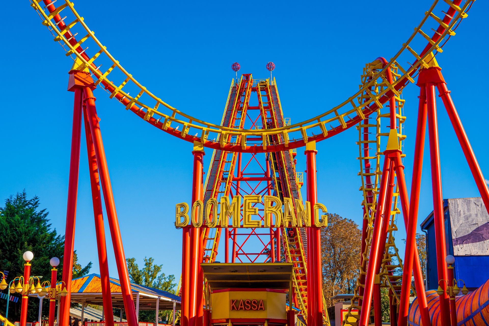 Bright red and yellow Boomerang roller coaster in Vienna, Austria amusement park.