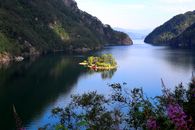 Yellow Kayak on Lake Near Green Mountains