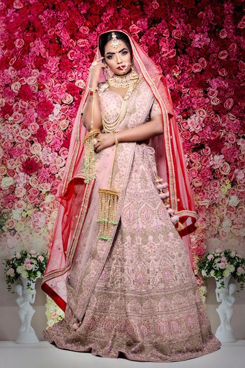 Serious Indian female wearing traditional bridal clothes with accessories