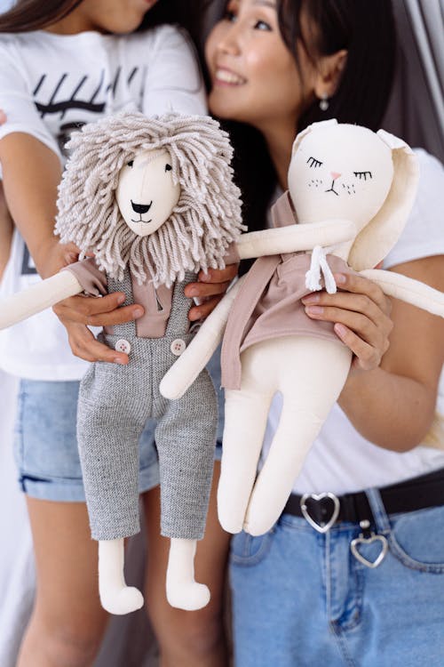 Photograph of a Mother and Her Daughter Holding Stuffed Toys