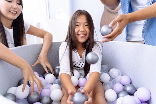 Free Photo of a Kid Playing with Balls Stock Photo