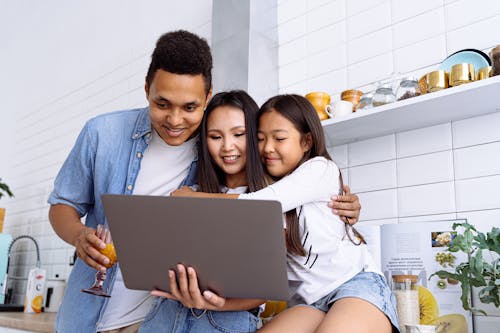 Free People Looking at the Screen of a Laptop Stock Photo