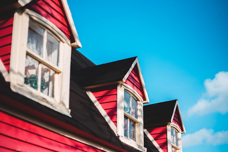 Colorful Attic Windows Of Old House In Daylight