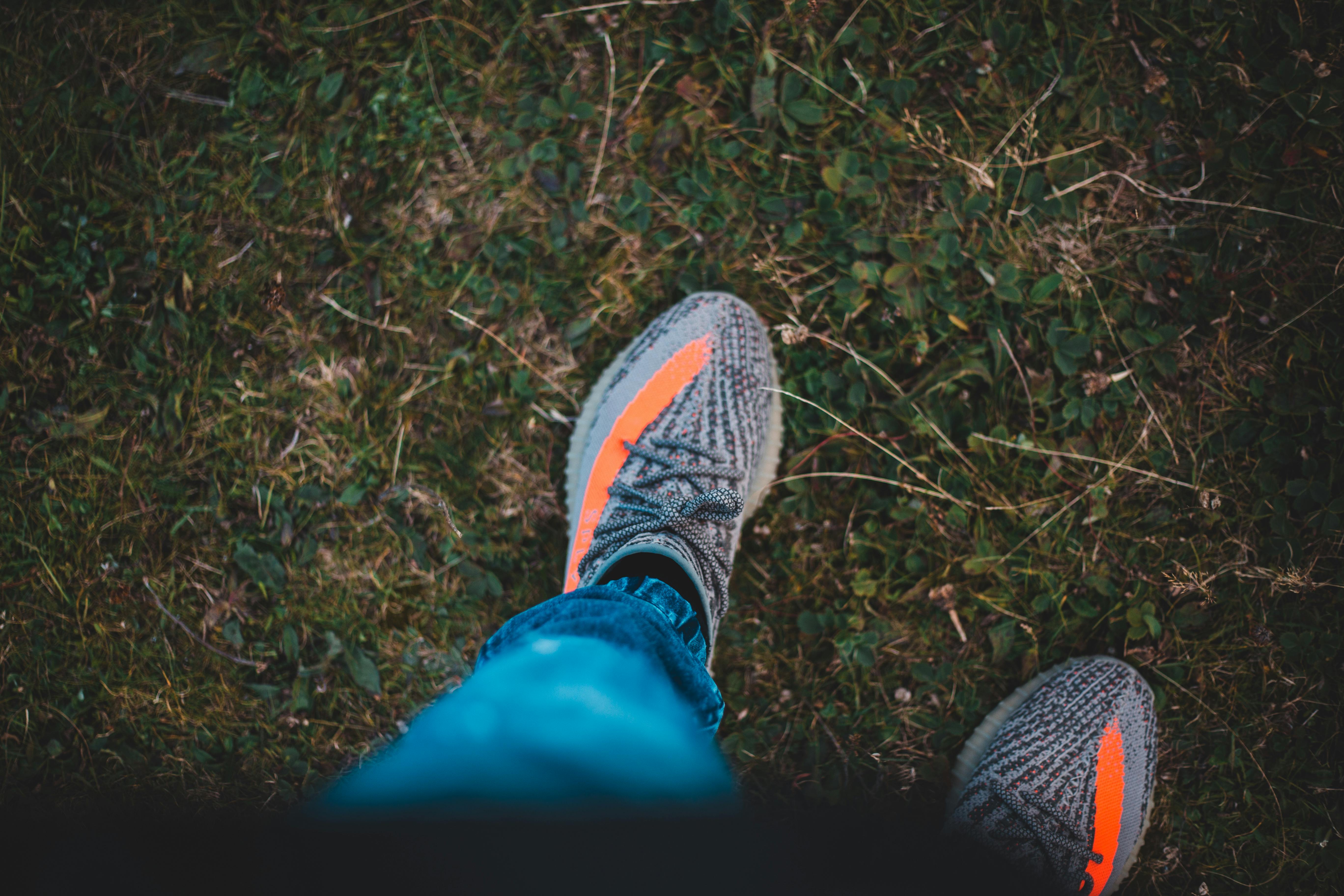 Woman chilling in meadow with headphones on legs · Free Stock Photo