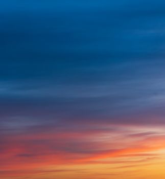 Captivating sunset sky with vivid color gradients blending from blue to orange.