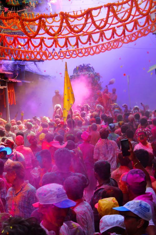 Crowd Covered With Colored Powders