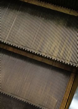 Detailed view of escalator steps showing parallel metal lines.