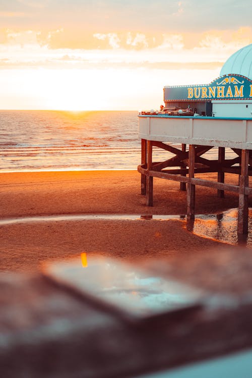 Photo of Dock on Seashore during Sunset