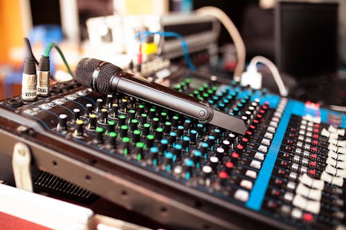 Free Soft focus of microphone placed on soundboard in sound recording studio at daytime Stock Photo