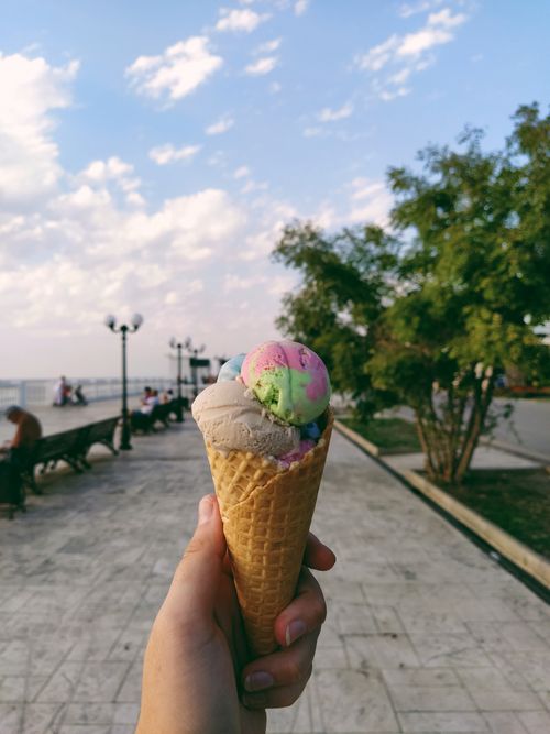 Free Hand holding a colorful ice cream cone at a seaside park in Anapa, Russia. Stock Photo